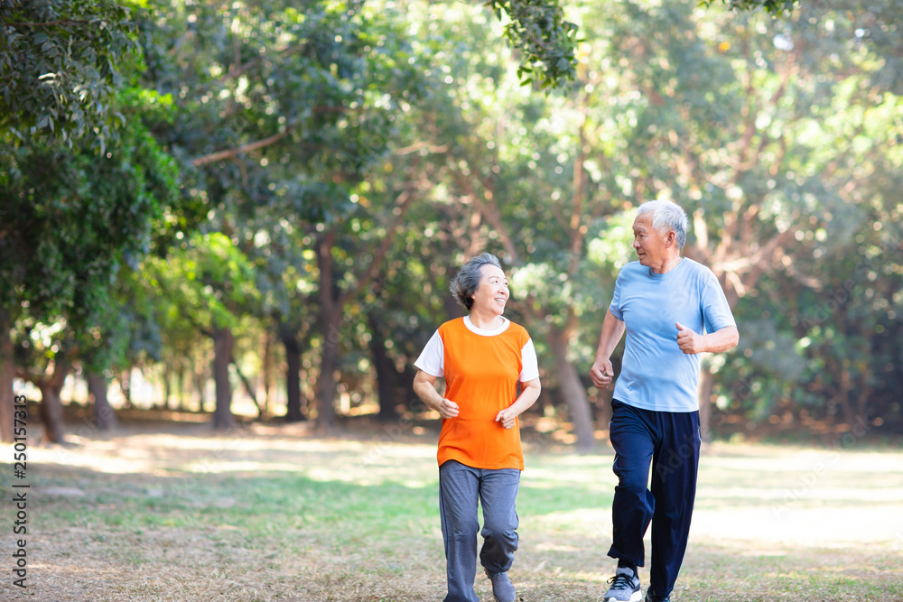 happy Senior couple running in the park