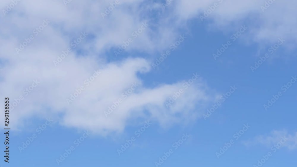 Airplane Flying through the White Clouds in a Blue Sky Airplane Flying through the White Clouds in a Blue Sky