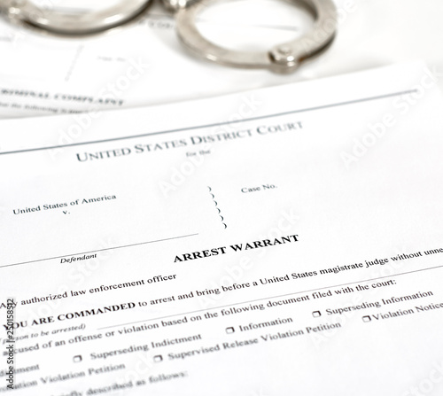 Arrest Warrant Court papers with Handcuffs