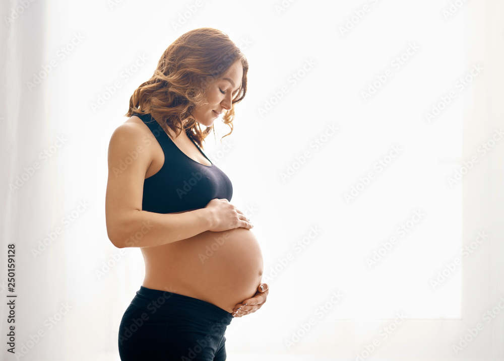 young pregnant woman - obrazy, fototapety, plakaty 