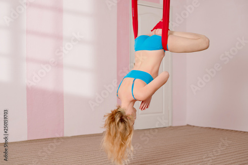 Fly yoga. The girl performs aerial yoga exercises