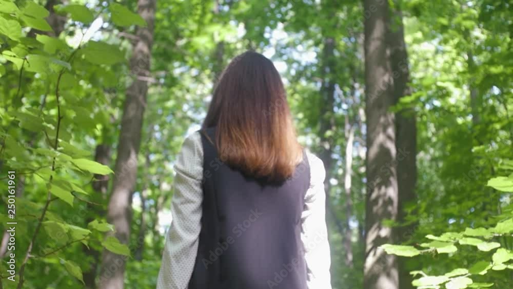 Beautiful girl walking in the leafy green forest Beautiful girl walking in the leafy green forest