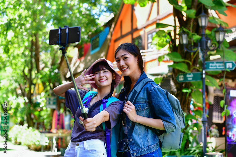 Travel and relaxing Concepts, Tourists are taking photos in the city. Asian girls are happily traveling. Beautiful girl is relaxing Travel. Asian girls are traveling in Asia.