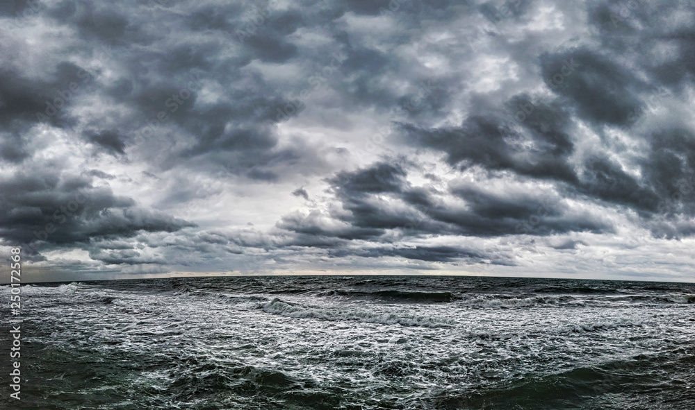 Dramatic cloudy sky and top seascape in a winter day with bad weather