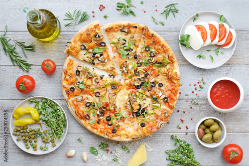 Italian food. Pizza, caprese salad and appetizers. Light gray background