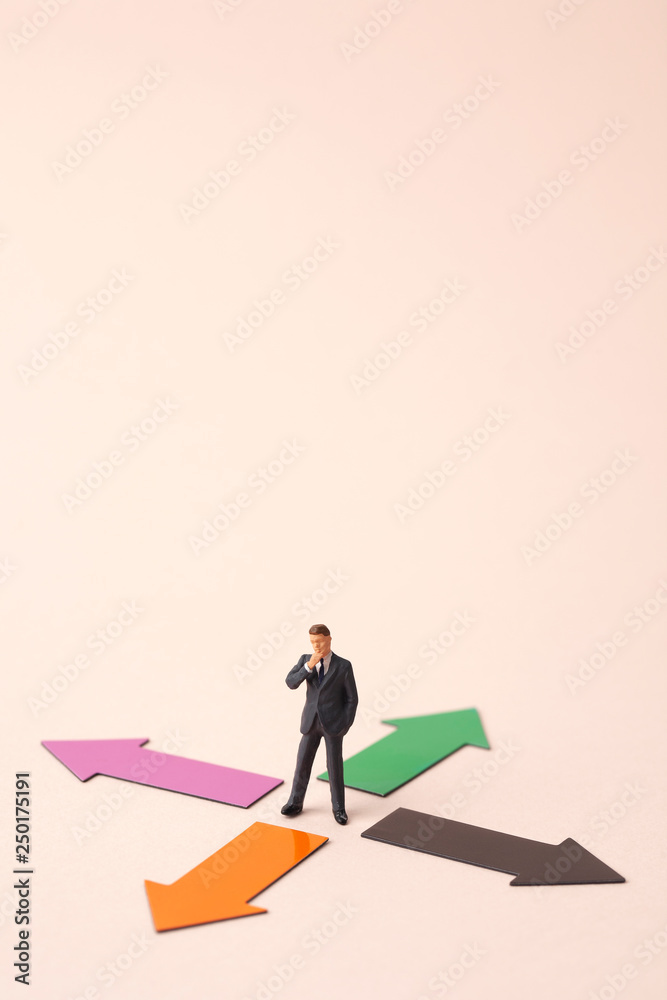 four direction arrows with miniature business man four direction arrows with miniature business man