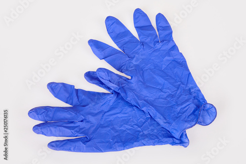 Dark blue latex medical gloves isolated on white background. Medical accessories: pair of sterilized surgical gloves.