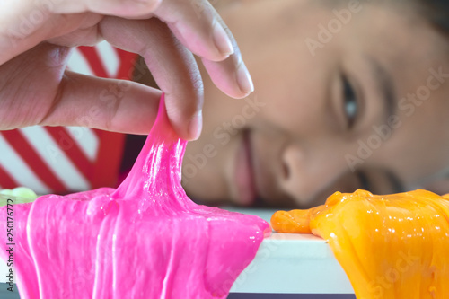 Hand Holding Homemade Toy Called Slime, Kids having fun and being creative by science experiment.