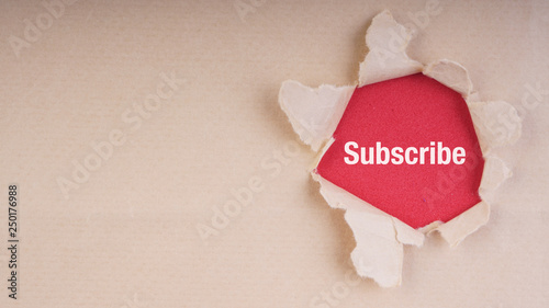 SUBSCRIBE text on brown envelope and torn paper. Concept Image