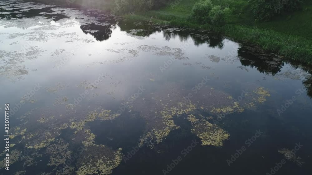 Aerial view of a lake with forest and sunset Aerial view of a lake with forest and sunset