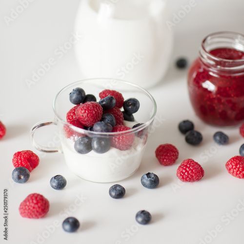 Dairy dessert. Fruit with whipped cream and yogurt. Blueberries, raspberries, yogurt