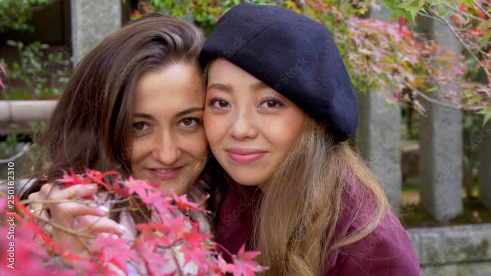 Beautiful women posing for camera with Fall foliage, 4K. Beautiful women posing for camera with Fall foliage, 4K.