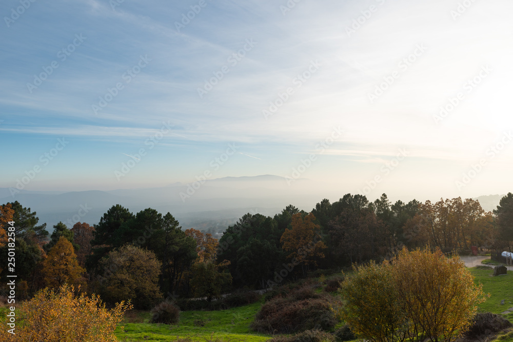 Obraz premium autumn landscape various colors, brown, yellow blue with some mountains among the clouds