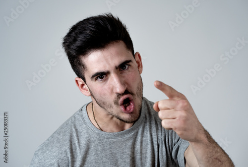 Human expressions and emotions. Young attractive aggressive man with an angry face