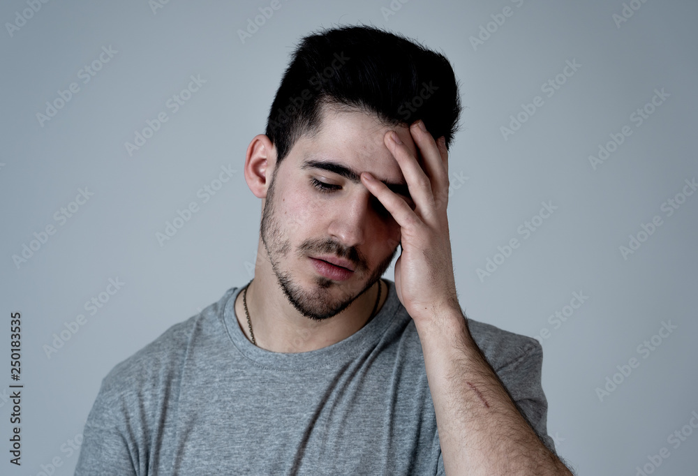 Human expressions, emotions. Young attractive man with sad face, looking depressed and unhappy Human expressions, emotions. Young attractive man with sad face, looking depressed and unhappy