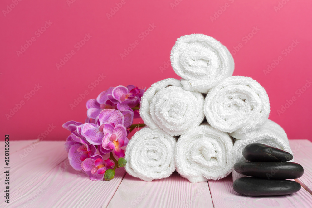 clean soft towels with flower on wooden table clean soft towels with flower on wooden table
