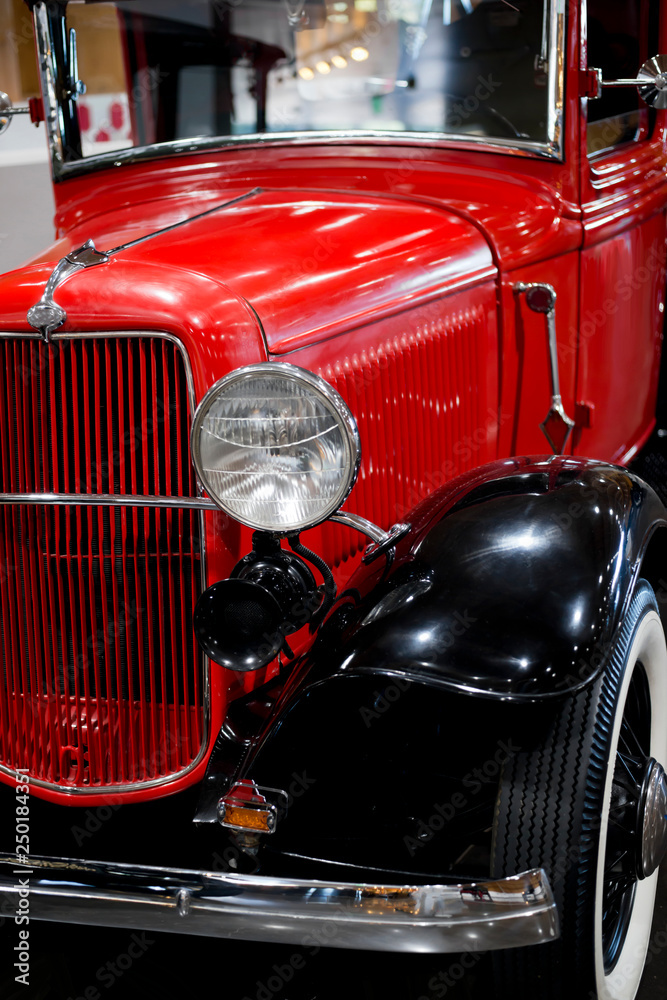 Front view of an elegant red retro car on exhibition of old vintage car