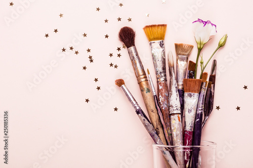 Art Brush Set and scattering of gold stars on pale pink background