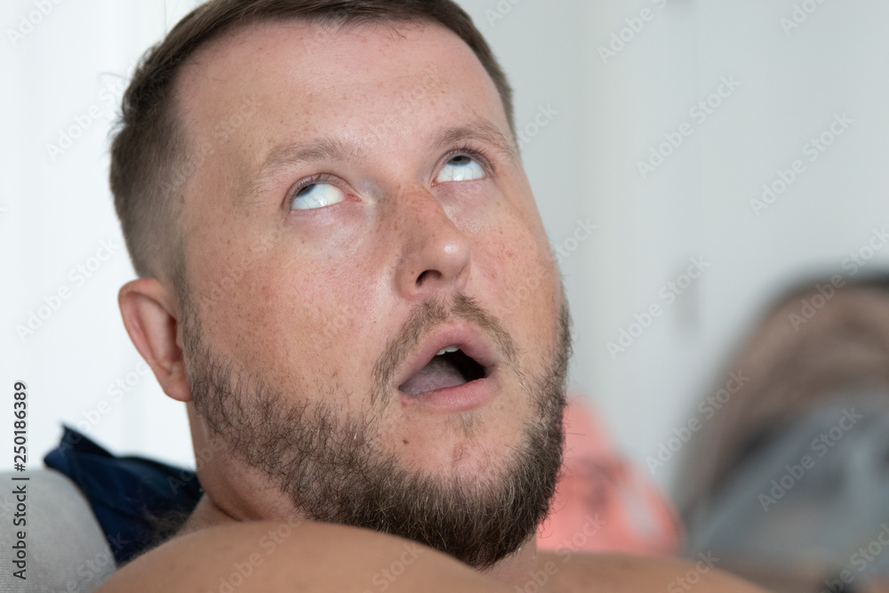Obraz premium Depressed young businessman put finger to his temple like a gun and rolled up his eyes over