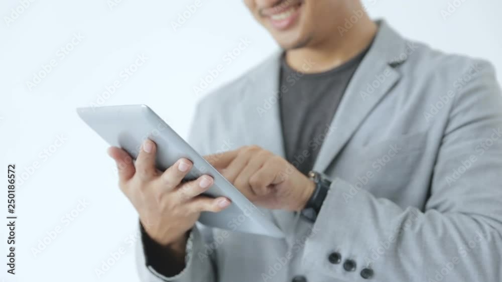 Young business man look so enjoy playing with his tab Young business man look so enjoy playing with his tab