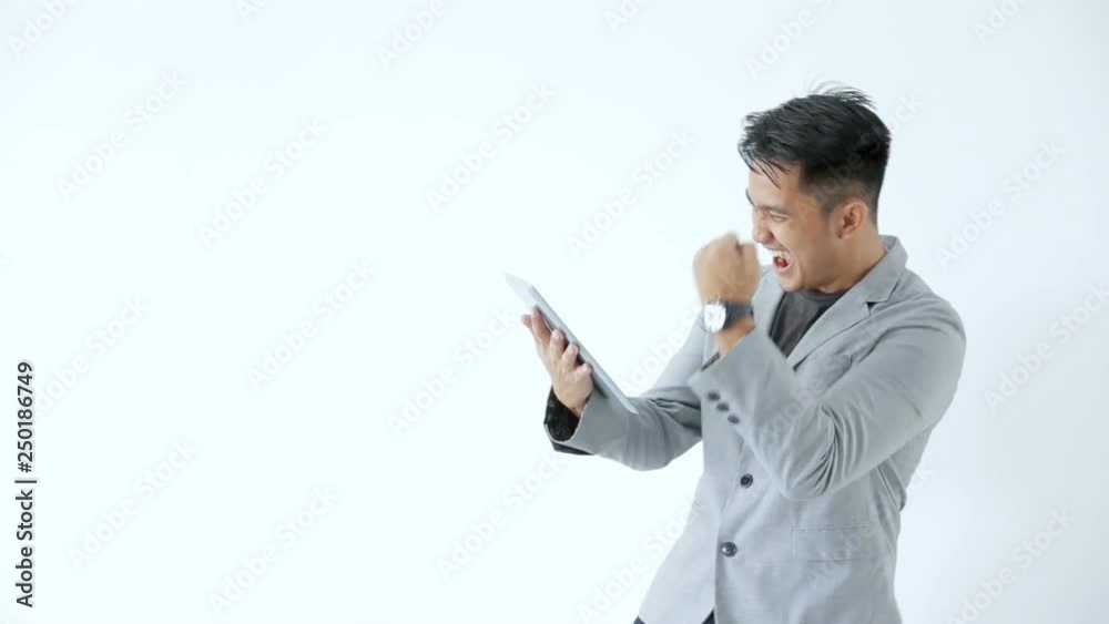 Young business man look so enjoy playing with his tab Young business man look so enjoy playing with his tab