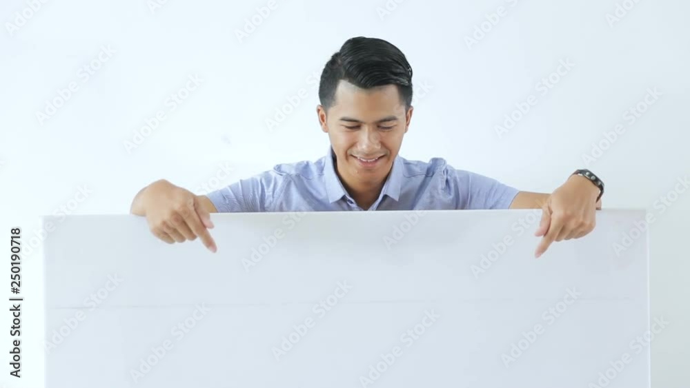 Pose of young business man holding and pointing a free space Pose of young business man holding and pointing a free space