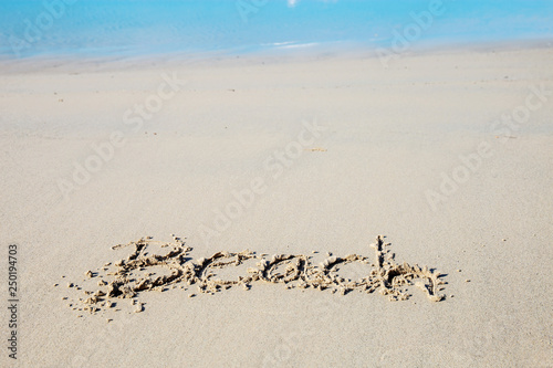 Writing beach on sand.