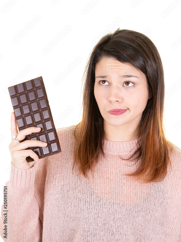 Portrait of beautiful woman holding chocolate bar in white background Portrait of beautiful woman holding chocolate bar in white background