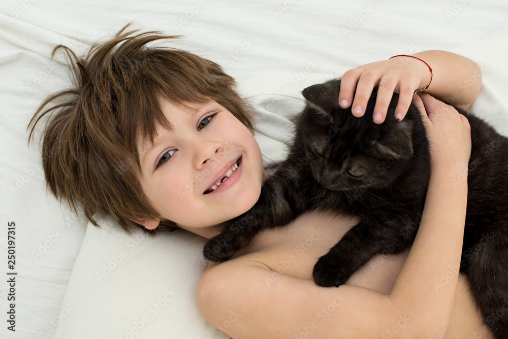 boy with a cat. A child of 6 years without a tooth. boy with a cat. A child of 6 years without a tooth.
