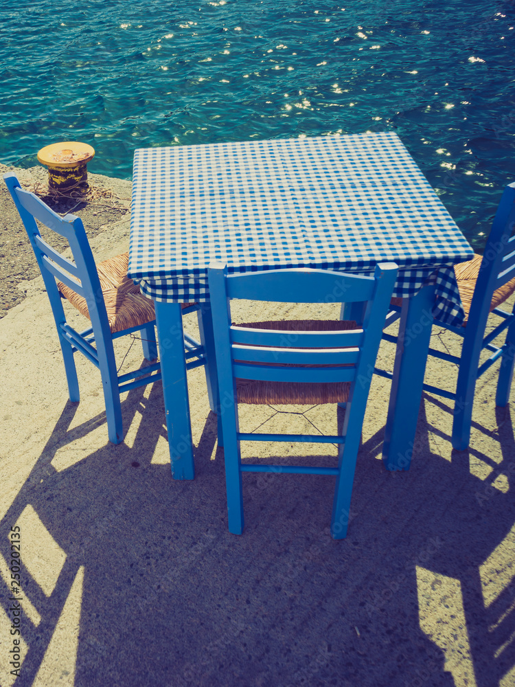 Open cafe outdoor restaurant in Greece on sea shore Open cafe outdoor restaurant in Greece on sea shore