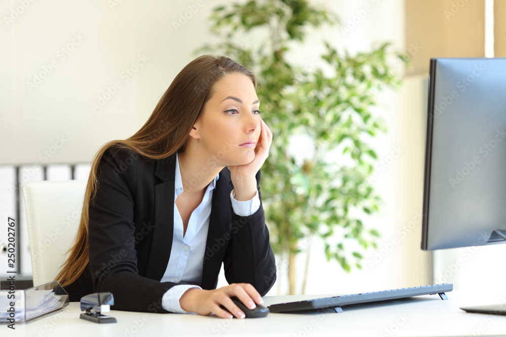 Confused office worker checking computer content Confused office worker checking computer content