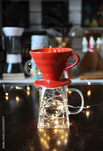 Luminous garland inside the jug with v60 dripper for coffee brewing. Allegory creative art visualization of bright taste photo