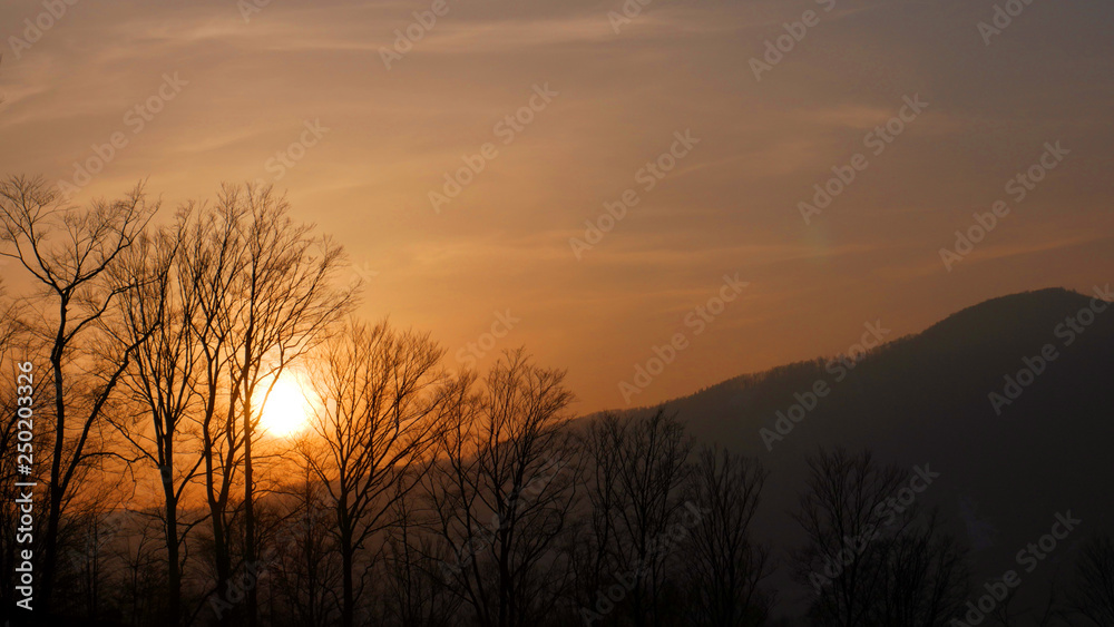 Amazing and beautiful view of the mountains in the rays of the setting sun