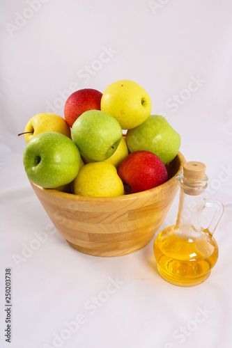 Fresh apples in a wooden vase. Green  yellow and red apples isolated on white