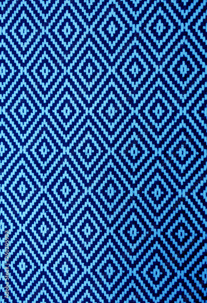 Vertical image of vibrant blue and navy blue ethnic pattern fabric front view Vertical image of vibrant blue and navy blue ethnic pattern fabric front view