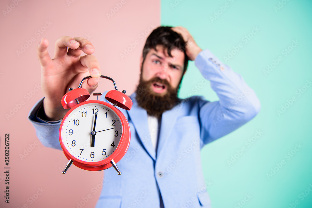How much time left till deadline. Time to work. Man bearded stressful businessman hold clock. Stress concept. Hipster stressful working schedule. Businessman has lack of time. Time management skills - obrazy, fototapety, plakaty 