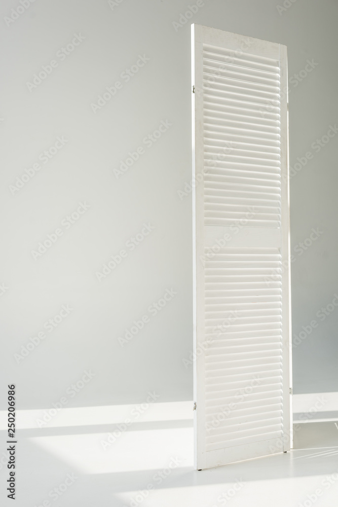 Fototapeta premium white textured door standing on grey background