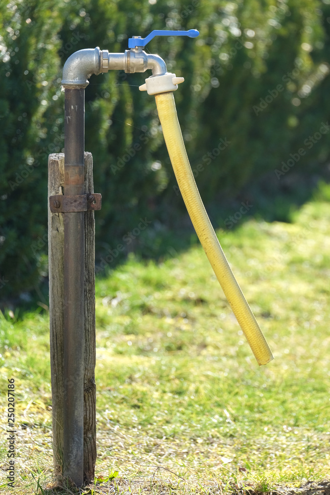 an outdoor faucet in the garden an outdoor faucet in the garden