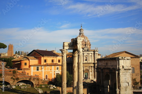 Ruins of Roman Forum. Temple of Vespasian and Titus, Arch of Septimius Severus and church of Santi Luca e Martina in Rome. Italy photo