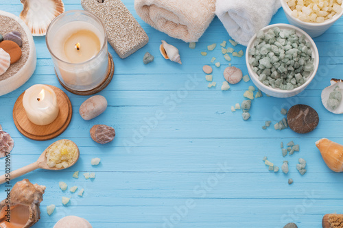 Spa concept with candles on blue wooden background