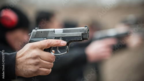 Close-up view of shooter practice handgun shooting in row group