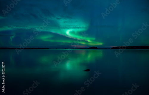 Northern lights background in Farnebofjarden national park in Sweden.