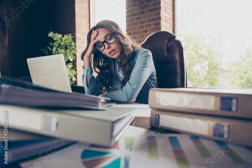 Close up photo beautiful she her business lady tired of bookkeeping running time last minutes seconds until boss chief come back mess papers hold head unwell sit office chair wearing formal wear suit photo