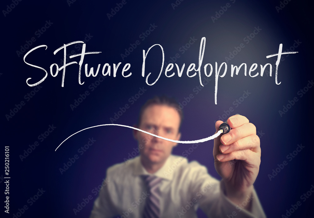 A businessman writing a Software Development concept with a white pen on a clear screen. A businessman writing a Software Development concept with a white pen on a clear screen.