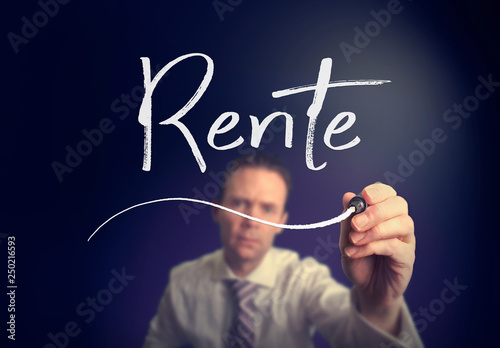 A businessman writing a Pension "Rente" concept in German with a white pen on a clear screen.