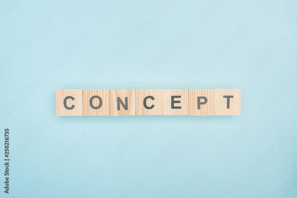 top view of concept lettering made of wooden cubes on blue background top view of concept lettering made of wooden cubes on blue background