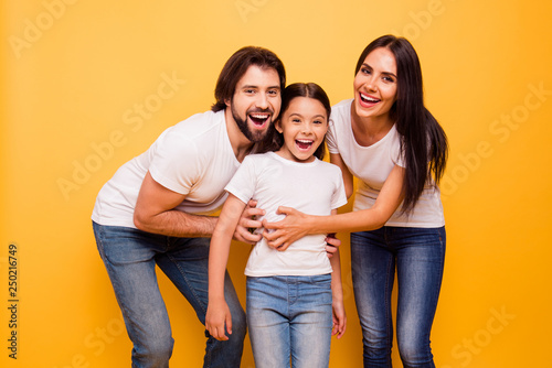Portrait of nice cute lovely charming adorable attractive cheerful cheery people having fun playing free time isolated over shine vivid pastel yellow background