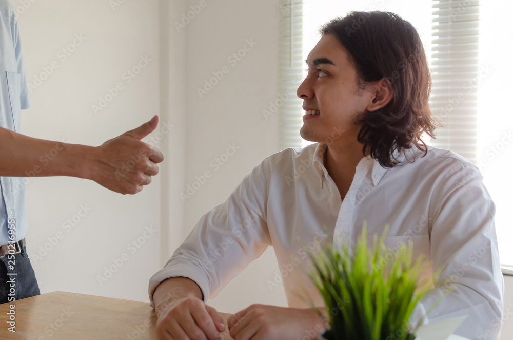 Good job man. Boss team leader encourage and showing thumbs up expressing positive successful to young man employee smiling in meeting room at home office company, encouragement and teamwork concept Good job man. Boss team leader encourage and showing thumbs up expressing positive successful to young man employee smiling in meeting room at home office company, encouragement and teamwork concept