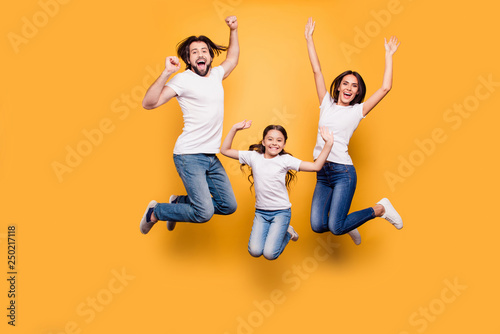 Full length body size portrait of nice lovely adorable attractive positive cheerful people dad daddy mom mommy spending spare free time isolated over shine vivid pastel yellow background