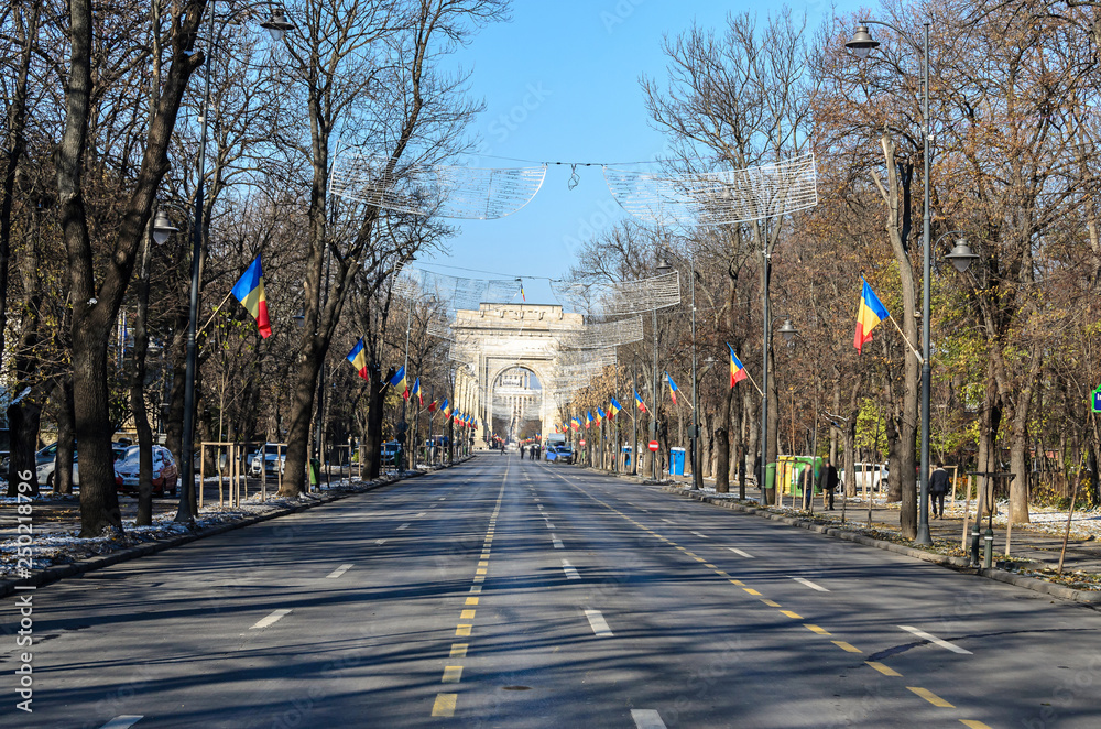 National Day of Romania (Ziua Nationala Centenar) at The Arch of Triumph (Arcul de Triumf) from Bucharest Romania, International Day with romanian flags, view from Kisseleff Avenue